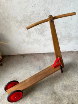 Holzroller mit roten Rädern