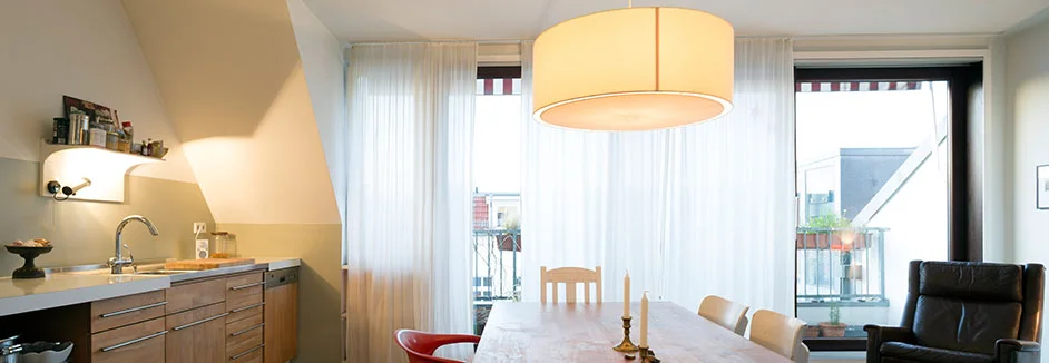 Heller Essbereich mit offener Küche und Balkon