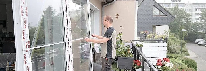 Person baut eine Terrassentür ein
